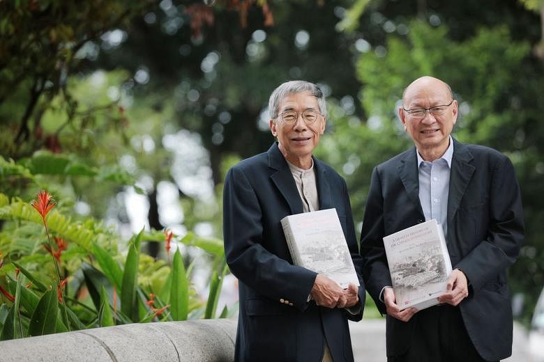 Historians Kwa Chong Guan (left) and Kua Bak Lim with copies of the newly launched English edition of A General History Of The Chinese in Singapore, of which they are co-editors.