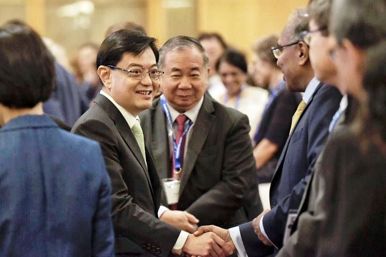 Deputy Prime Minister Heng Swee Keat meeting delegates at the 10th International Conference on Materials for Advanced Technologies at Marina Bay Sands yesterday. He said that as a result of Singapore investing in science and technology R&D since almo
