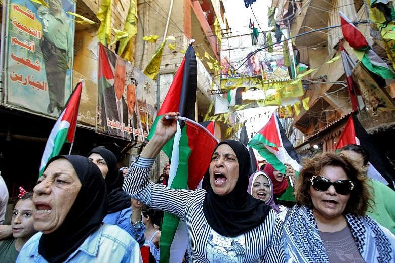 Palestinian women protesting in a refugee camp in Lebanon against the economic formula proposed by the United States for Israeli-Palestinian peace. PHOTO: DPA