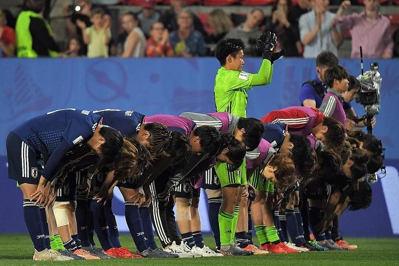 Japan's players bow in acknowledging their supporters after their 2-1 loss to the Netherlands in the round of 16. The Japanese, World Cup finalists in 2015, fell to a late penalty. Below: Wang Shuang failed to shine for China in their 2-0 defeat by I