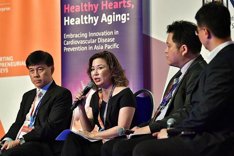 Associate Professor Angelique Chan, executive director of the Centre for Ageing, Research and Education at Duke-NUS Medical School, speaking at the Healthy Hearts, Healthy Ageing Asia Pacific Report launch. With her is National University Heart Centr