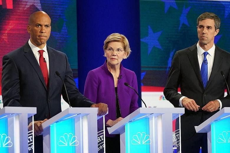 From left: Senators Cory Booker and Elizabeth Warren and former Texas congressman Beto O'Rourke taking part in the first Democratic presidential debate in Miami on Wednesday night.