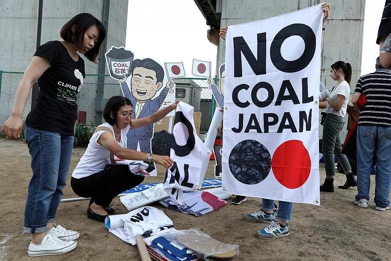 Environmental activists gathering in neighbouring Kobe city yesterday as world leaders arrived in Osaka for the G-20 Summit, to protest against Japan's support for new coal-fired power generation projects. US President Donald Trump meeting Australian