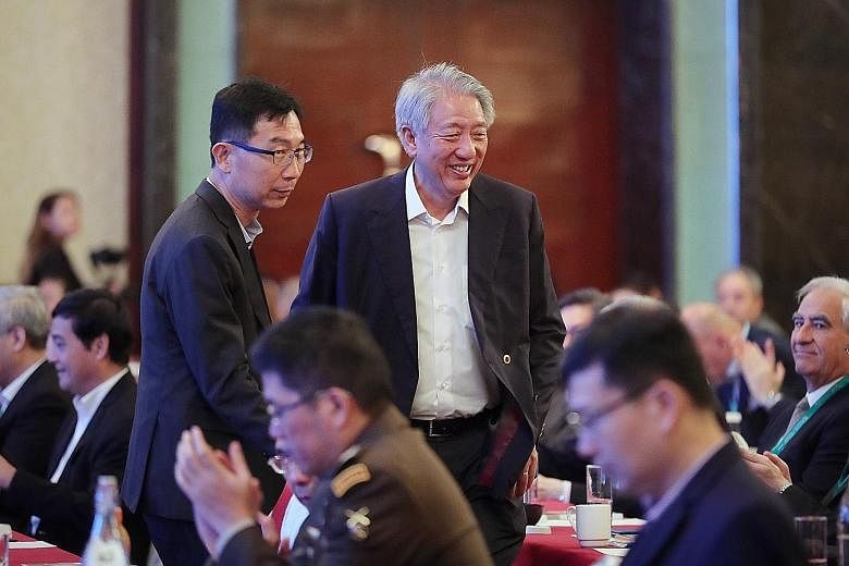 Senior Minister Teo Chee Hean, who is also Coordinating Minister for National Security, arriving at the second Singapore Defence Technology Summit at Shangri-La Hotel yesterday with the Defence Science and Technology Agency's chief executive Tan Peng