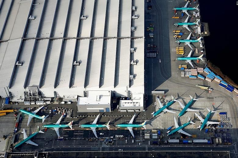 Boeing's 737 Max airplanes parked on the tarmac at the Boeing factory in Renton, Washington. The US planemaker must address the new safety issue - discovered during a simulator test last week - before the jet, which was grounded in March in the wake 