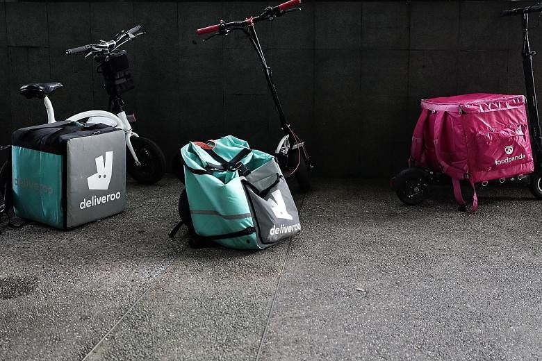 Deliveroo said all 6,000 of its riders have been covered by insurance for free since May last year, while Grab, which runs GrabFood, has also taken up insurance for its riders. ST understands Foodpanda is looking to do the same. ST PHOTO: KELVIN CHNG