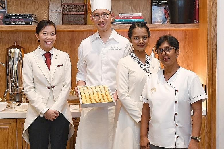 (From left) Raffles Hotel head butler Grace Kiong, executive pastry chef Tai Chien Lin, junior lobby ambassador Shobana S. Muthiah and senior housekeeping supervisor Vaithilingam Krishnaveny stand to benefit from the new initiatives - one of which is