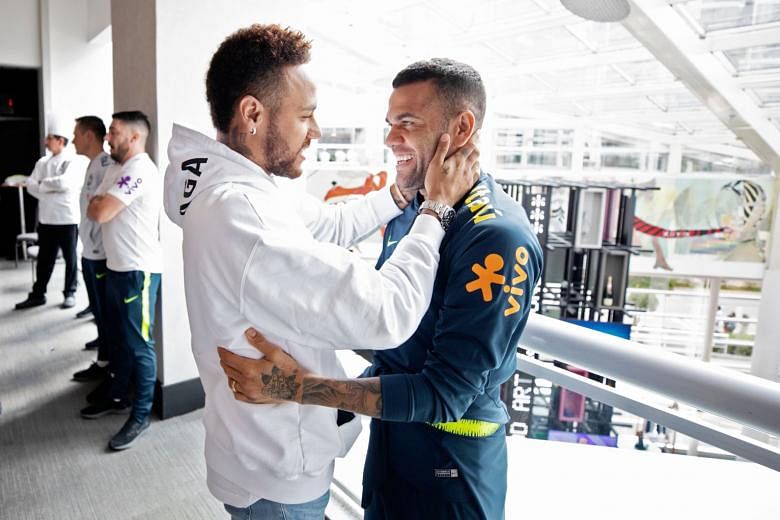 Neymar chatting with former Barcelona and Paris St-Germain teammate Dani Alves, who replaced him as Brazil captain for the Copa America, at the team hotel in Sao Paulo last week. Injured Neymar is angling for a move away from the French club and retu