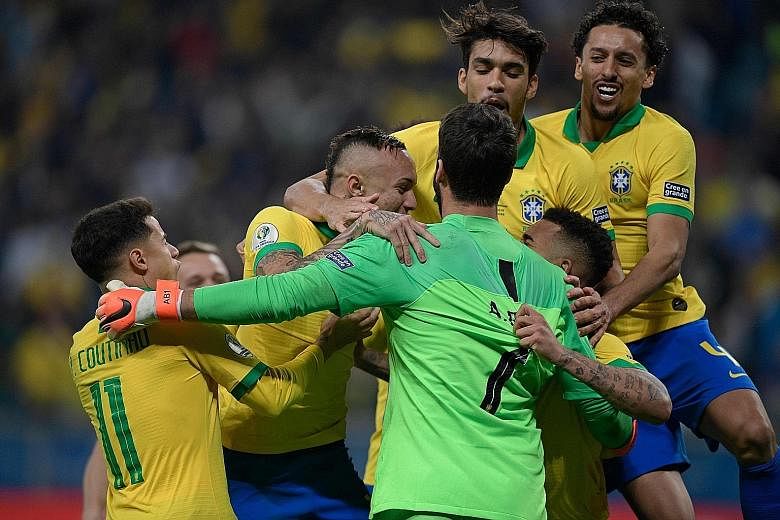 Brazil players including Philippe Coutinho and Alisson celebrating after beating Paraguay in a shoot-out in their Copa America quarter-final on Thursday. Brazil were eliminated by Paraguay in 2011 and 2015.