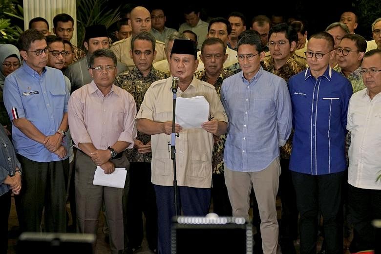 Mr Prabowo Subianto and his vice-presidential pick Sandiaga Uno at a news conference in Jakarta on Thursday, after Indonesia's Constitutional Court dismissed all his claims of "massive, structured and systematic" electoral fraud. He said: "We believe