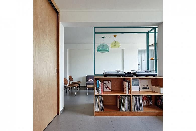  Furnishings such as Kartell FL/Y hanging lamps and a maxi Swatch wall clock add colour and interest to the flat. A second-hand turntable (above) is a favourite feature among the home owner's friends.