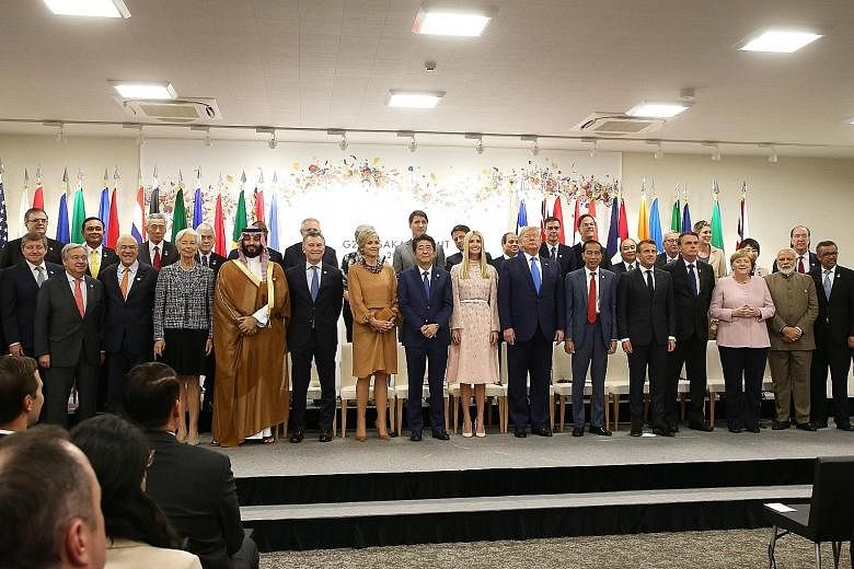 Prime Minister Lee Hsien Loong (second row, third from left) with world leaders during an event on the theme, "Promoting the place of women at work", on the sidelines of the G-20 Summit in Osaka yesterday. During the summit, leaders were split over h