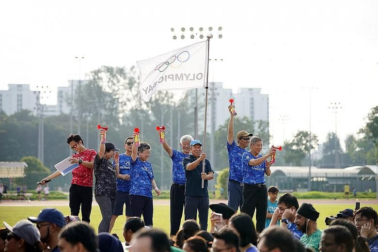 International Olympic Committee executive board member and Singapore Olympic Foundation chairman Ng Ser Miang flagging off the Olympic Day Walk in celebration of the 2019 Olympic Day in conjunction with the Singapore Tennis Festival yesterday. More t