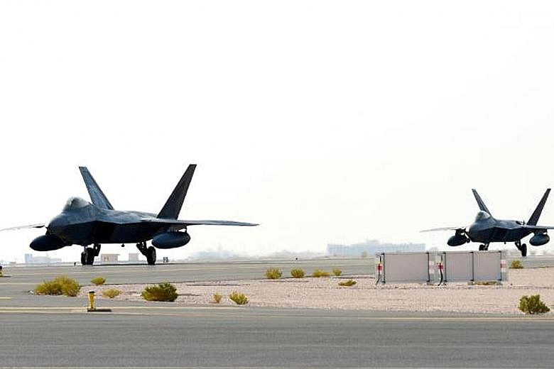 US Air Force F-22 Raptors arriving at Al Udeid Air Base in Qatar on Thursday. Last month, the air force deployed several nuclear-capable B-52 bombers to the Gulf in response to what the Defence Department described as a possible plan by Iran to attac