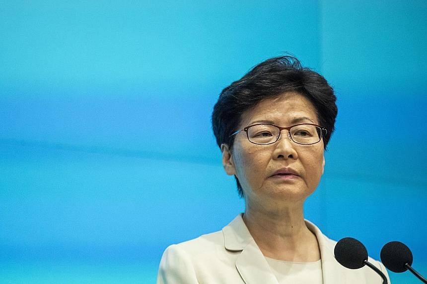 Demonstrators rallying in support of the police outside the Legislative Council in Hong Kong yesterday. The city's administration, led by Chief Executive Carrie Lam (above), is in a deadlock with protesters over a proposed controversial extradition l
