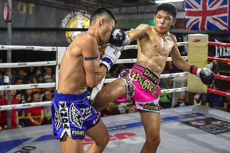 Brandon Ng (in pink shorts) became Singapore's first World Boxing Council (WBC) muay thai national champion on Saturday night after he defeated Andre Seah via a unanimous decision to win the welterweight title at the Singapore Fighting Championship (
