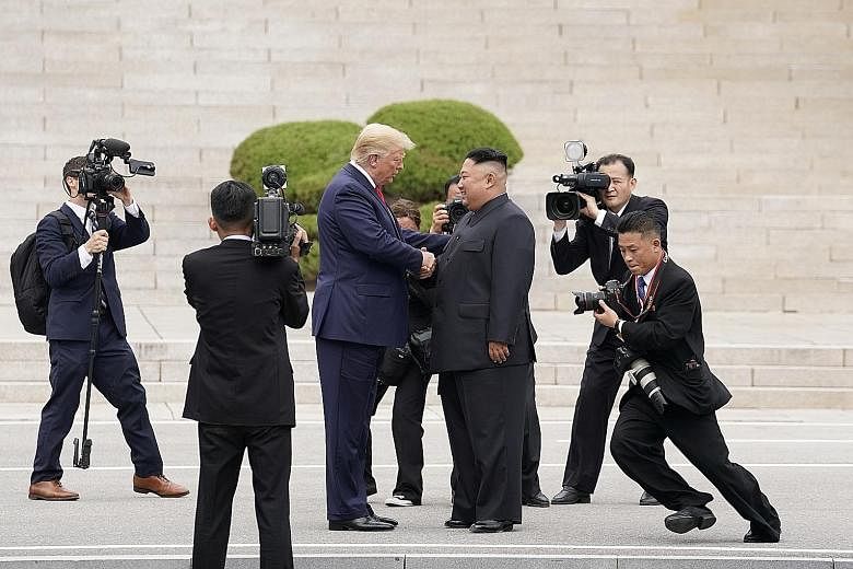 US President Donald Trump with North Korean leader Kim Jong Un on North Korea's side of Panmunjom truce village in the Demilitarised Zone. Mr Trump walked a few steps across the North Korean border and posed for photos, making him the first US presid