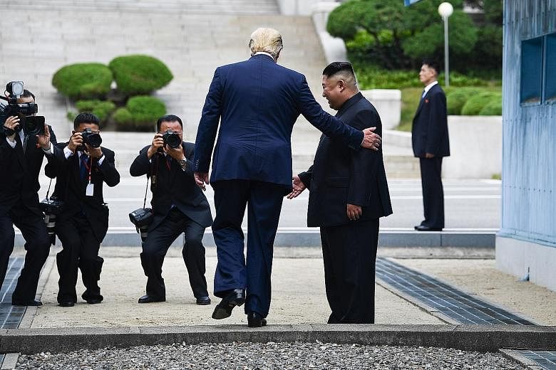 United States President Donald Trump stepping into the North Korean side of the Military Demarcation Line (left), then stepping back into the South with North Korean leader Kim Jong Un yesterday. PHOTOS: AGENCE FRANCE-PRESSE, DPA