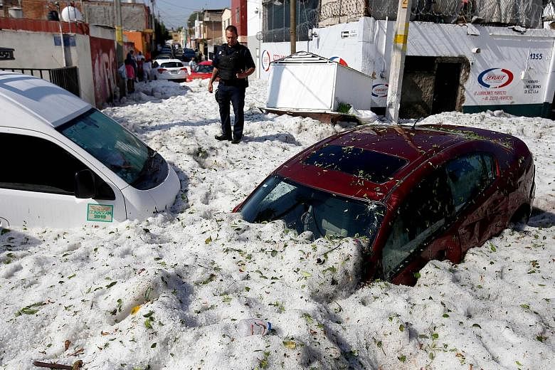 The accumulation of hail in the streets of Guadalajara buried vehicles and damaged about 200 homes and businesses on Sunday.