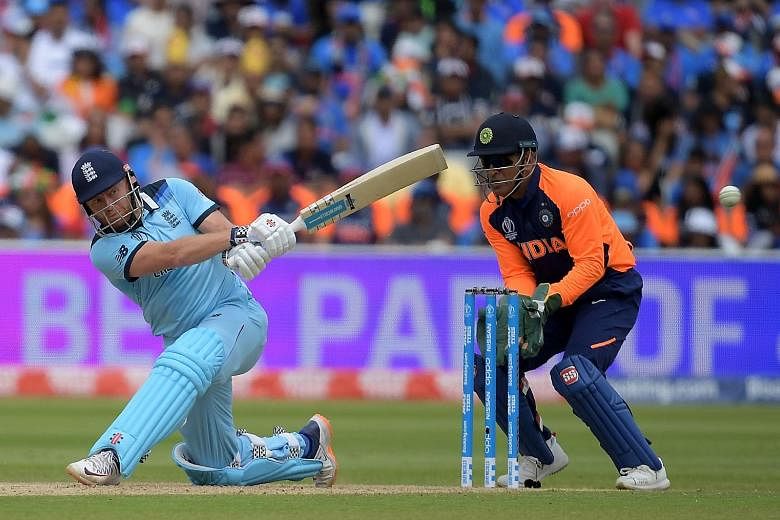 England's Jonny Bairstow, under the watchful eye of India wicketkeeper M.S. Dhoni, hitting the ball en route to a 111 from 109 balls during their Cricket World Cup round-robin match at Edgbaston in Birmingham on Sunday.