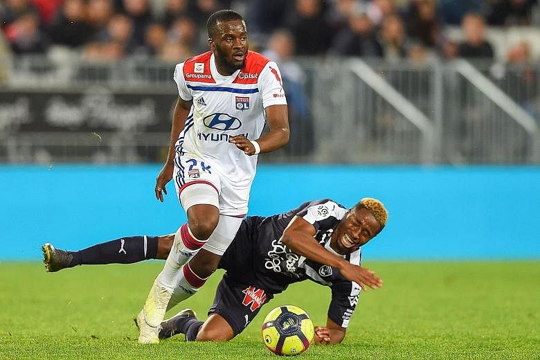 France midfielder Tanguy Ndombele, beating Bordeaux's Francois Kamano while playing for Lyon in a French Ligue 1 game in April, is Tottenham's No. 1 transfer target. PHOTO: AGENCE FRANCE-PRESSE