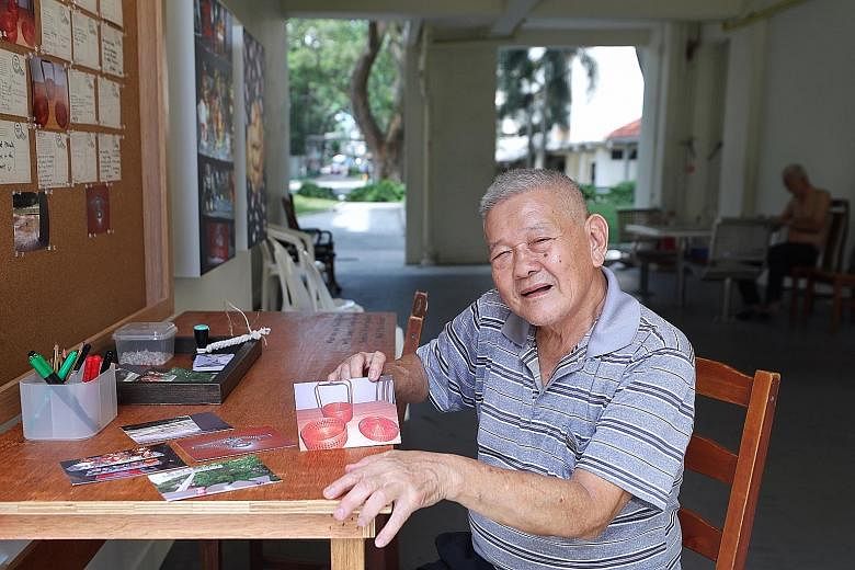 Retiree Jason Ong, 72, with a photo of a red traditional wedding basket used by his grandmother, mother and wife.