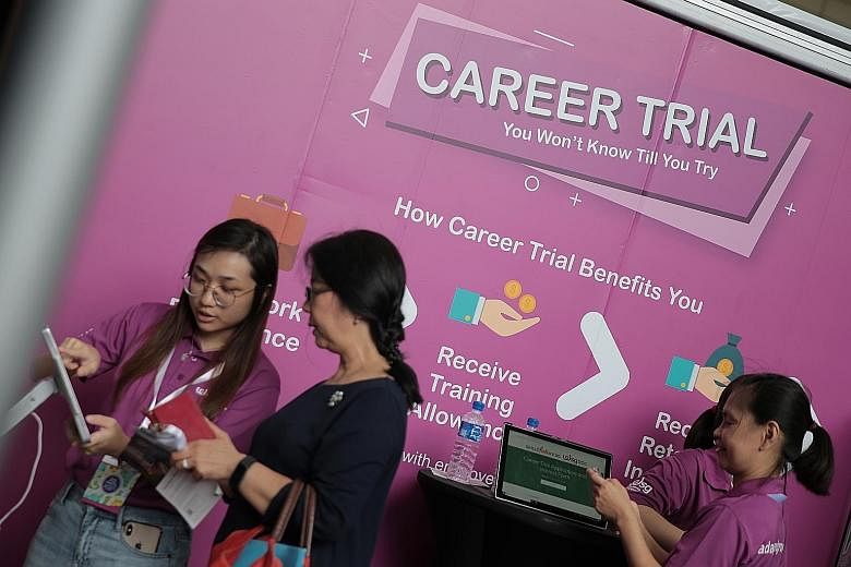 Mr Dicky Dzulkarnaen found a full-time job as a guest services officer at Park Regis Singapore through the Career Trial scheme. Workforce Singapore staff assisting a job-seeker at the Career Trial booth at the Adapt and Grow Career Fair at HDB Hub ye