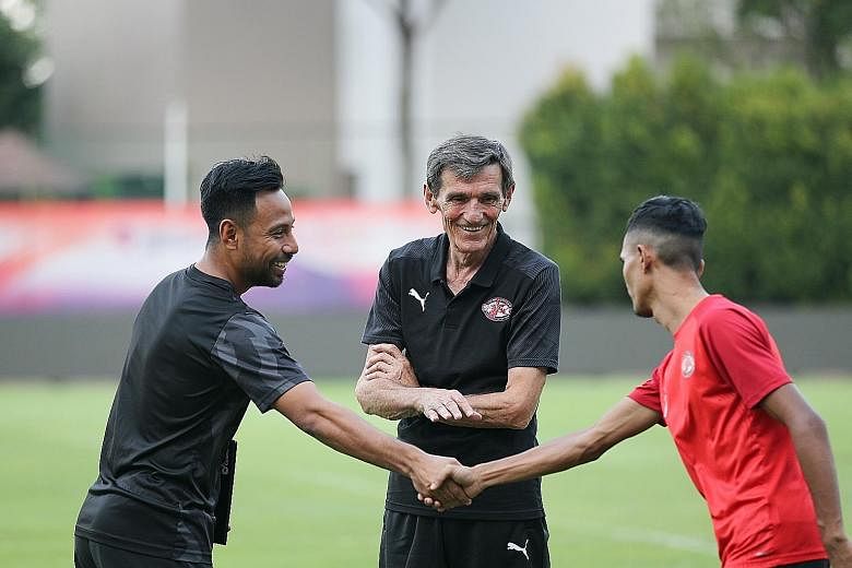 New Home United coach Raddy Avramovic getting to know his men better - with assistant coach Noh Rahman (far left) and player Aqhari Abdullah during training yesterday. ST PHOTO: ONG WEE JIN