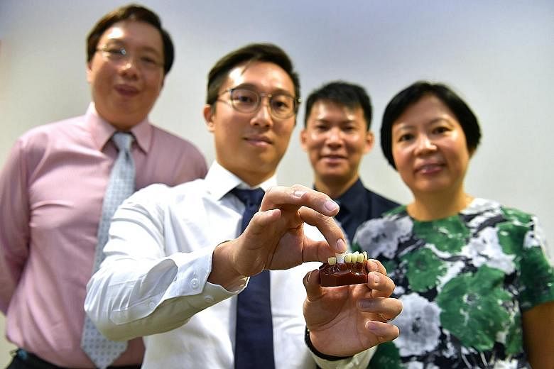 The 3D-printed dental plug aids bone growth in the jaw, reducing chances of bone shrinkage after an extraction. (From left) Chief executive of Singapore Clinical Research Institute Teoh Yee Leong, Osteopore chief technology officer Lim Jing, co-inves