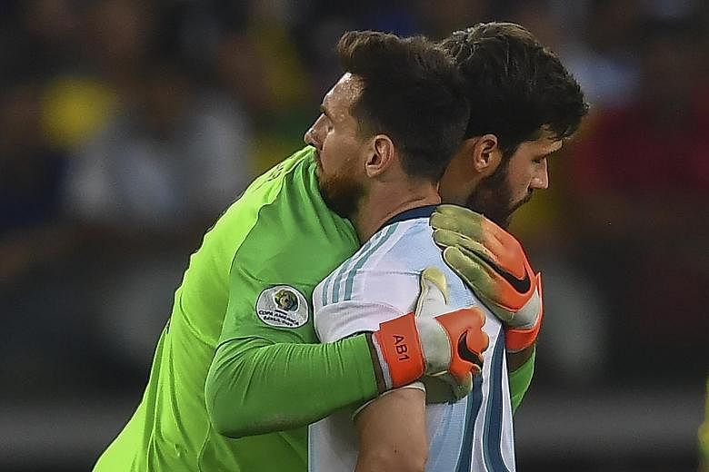 Argentina star Lionel Messi getting a hug from Brazil goalkeeper Alisson after the Copa America semi-final clash which ended 2-0 in Brazil's favour. PHOTO: AGENCE FRANCE-PRESSE