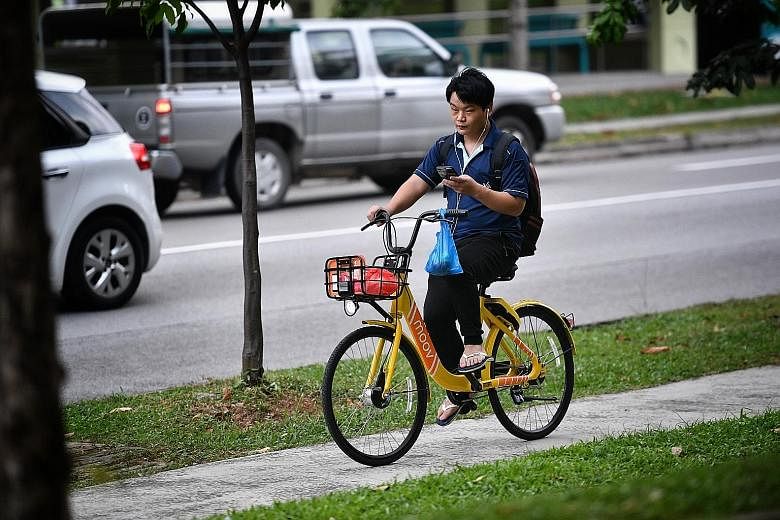 A Moov shared-bike user in Jurong West yesterday. The firm has a licence from LTA to operate up to 1,000 bicycles here.