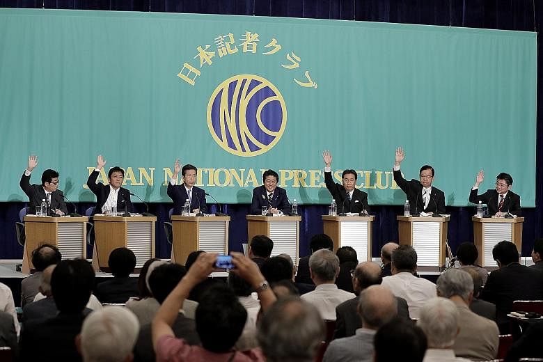 Japanese Prime Minister Shinzo Abe (centre), who is president of the Liberal Democratic Party, with other party leaders during a debate at the Japan National Press Club yesterday, ahead of Nomination Day for the Upper House election. PHOTO: BLOOMBERG