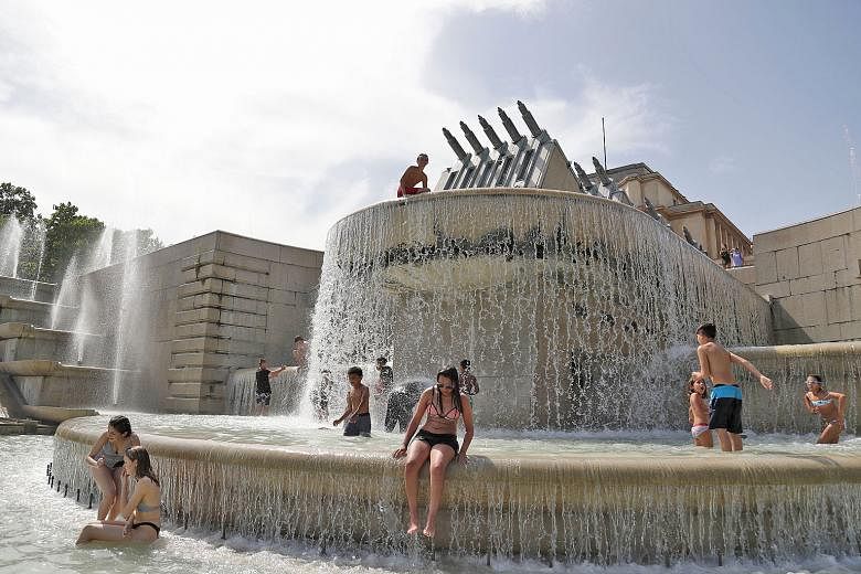 People cooling off at the Trocadero Fountain near the Eiffel Tower last week as temperatures in the French capital soared to a new record.