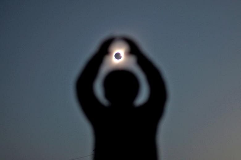 Astronomers and amateur skywatchers (left and above) were treated to a total solar eclipse in part of Chile's northern desert, an area famed for its clear skies and host to some of the world's largest telescopes. More than 200,000 people flocked to t