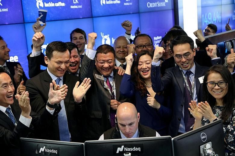 Mr David Li (second from left), CEO of Centurium Capital, celebrating the first trade of Luckin Coffee's stock with the start-up's executives during its Nasdaq debut in New York in May. Centurium was an early backer of the Chinese challenger to Starb