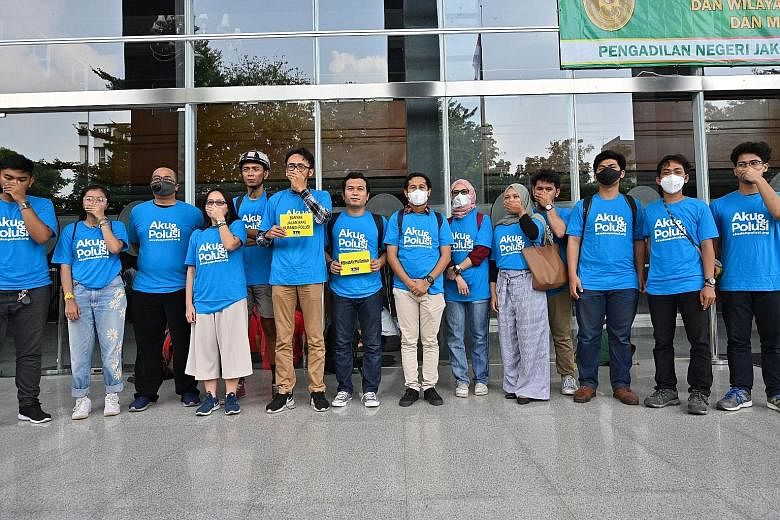 Indonesian environmental activists in protest mode after filing a lawsuit yesterday over Jakarta's toxic air pollution. PHOTO: AGENCE FRANCE-PRESSE