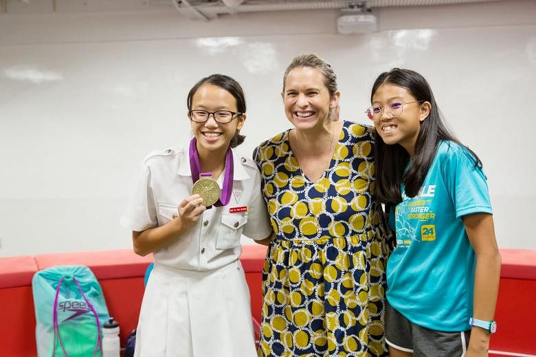 Four-time Olympic champion Libby Trickett with a pair of young athletes at the National Youth Sports Institute yesterday. The Australian was speaking to young swimmers at a sharing session. PHOTO: SINGAPORE OLYMPIC FOUNDATION