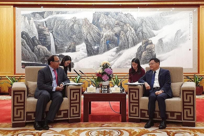 Minister for Communications and Information S. Iswaran discussing the smart city twinning initiative between Singapore and Shenzhen with the Chinese city's Communist Party secretary Wang Weizhong yesterday.