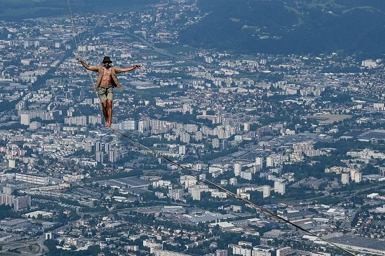 A man walking on a slackline during the 7th edition of the European Marmotte Highline Project festival in Lans-en-Vercors, near Grenoble, eastern France, on Thursday. A total of 20 highlines have been installed, most of them on the mountains surround