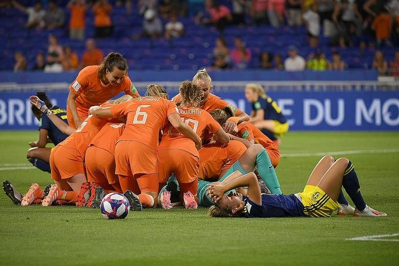 Netherlands players celebrating after the final whistle in their 1-0 semi-final win over Sweden. The Dutch, in the Women's World Cup final for the first time, are happy to play underdogs to the United States' favourites status. 