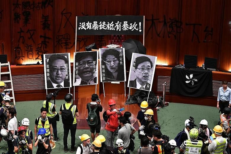 Protesters and media inside the Legislative Council building last Monday, on the 22nd anniversary of the handover of Hong Kong. Experts say the evolution of protests has been coloured by the larger political dynamic.