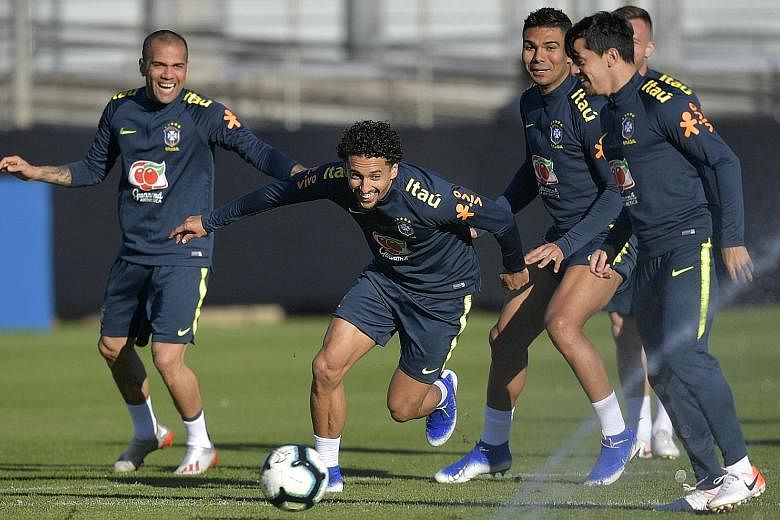 Above: Peru's Paolo Guerrero during training on Friday for today's final. Left: Brazil's players (from left) Dani Alves, Marquinhos and Casemiro having fun during training last month.