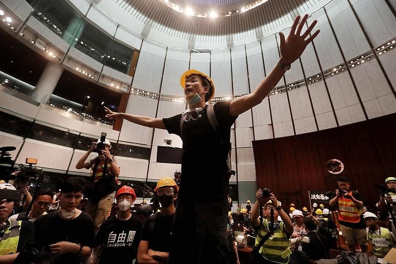 Protesters holding placards and strips of cloth with protest messages at last Friday's rally. But discontent had already reared its head during the Occupy Movement in 2014. The protesters broke into the Parliament chambers of the Legislative Council 