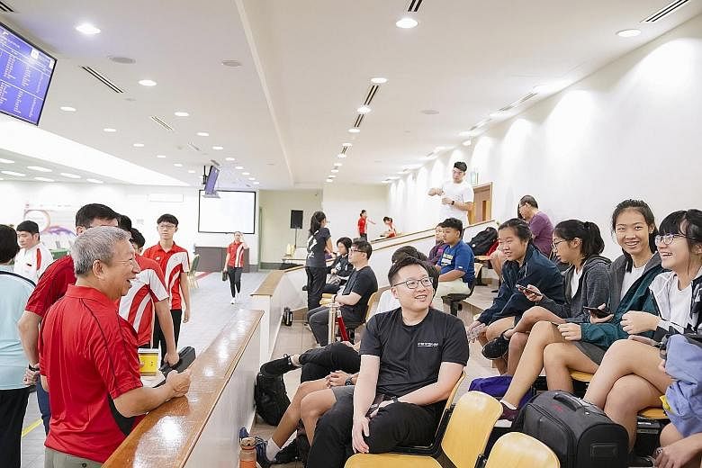Ng Ser Miang (left), chairman of the Singapore Olympic Foundation, chatting with some shooters at the opening ceremony of the Singapore Youth Olympic Festival at the Safra Indoor Air Weapon Range in Safra Yishun yesterday morning. Ng was the guest of