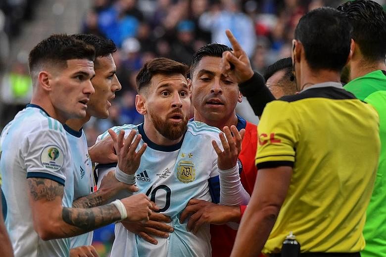 Argentina's Lionel Messi complaining to referee Mario Diaz de Vivar after he and Chile's Gary Medel (out of frame) were sent off in the third-place play-off on Saturday.