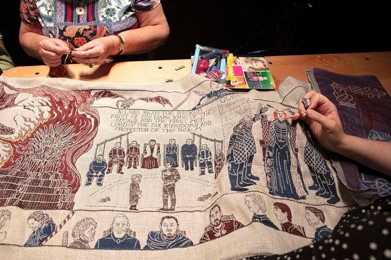 Seamstresses working on the final section of a tapestry depicting the gory battles of hit television series Game of Thrones at Ulster Museum in Belfast. The tapestry, woven of fine linen, includes the show's icons, like its "blood red weddings" and "