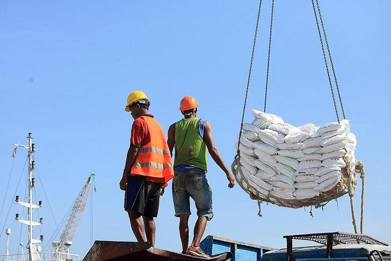 Workers at the port of Dili. Timor Leste needs to attract more investments in key industries such as tourism, energy and agriculture, as it strives to be an upper-middle income country.