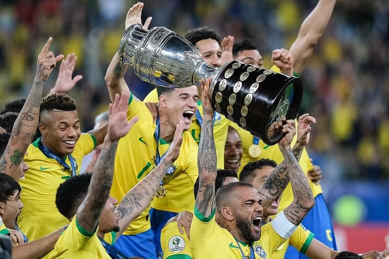 Brazil captain and Golden Ball winner Dani Alves hoisting the Copa America trophy after the hosts defeated Peru 3-1 in the final at the Maracana on Sunday. It was the Selecao's ninth triumph in the continental competition. Gabriel Jesus taking out hi