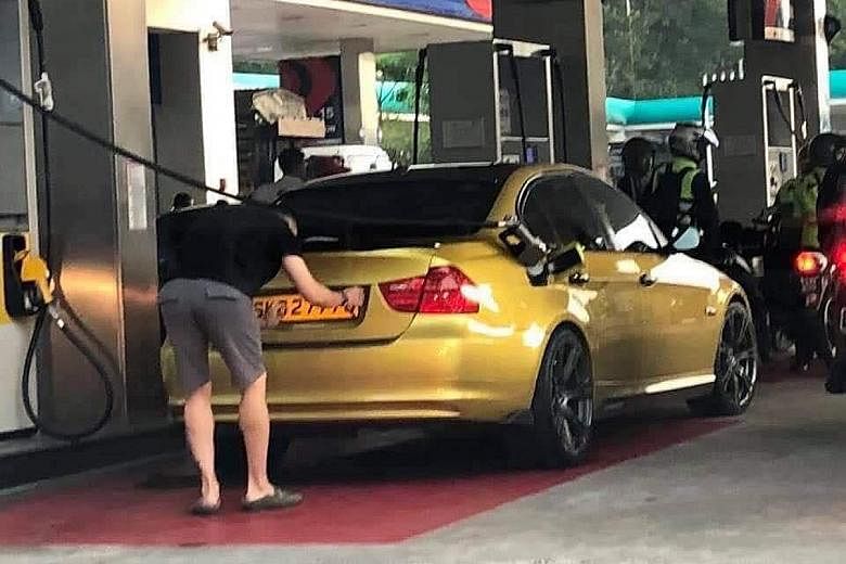 Tan Hock Lai was seen switching the licence plates on his BMW to those registered to a Hyundai owner at a petrol station in Johor. PHOTO: SIN CHEW DAILY