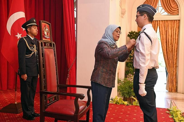 Boys' Brigade Senior Cadet Lieutenant Jason Timothy Pan receiving the President's Award from President Halimah Yacob at the Istana yesterday. Jason has served in the BB's 12I Singapore Company since 2010 and also actively contributes to the community